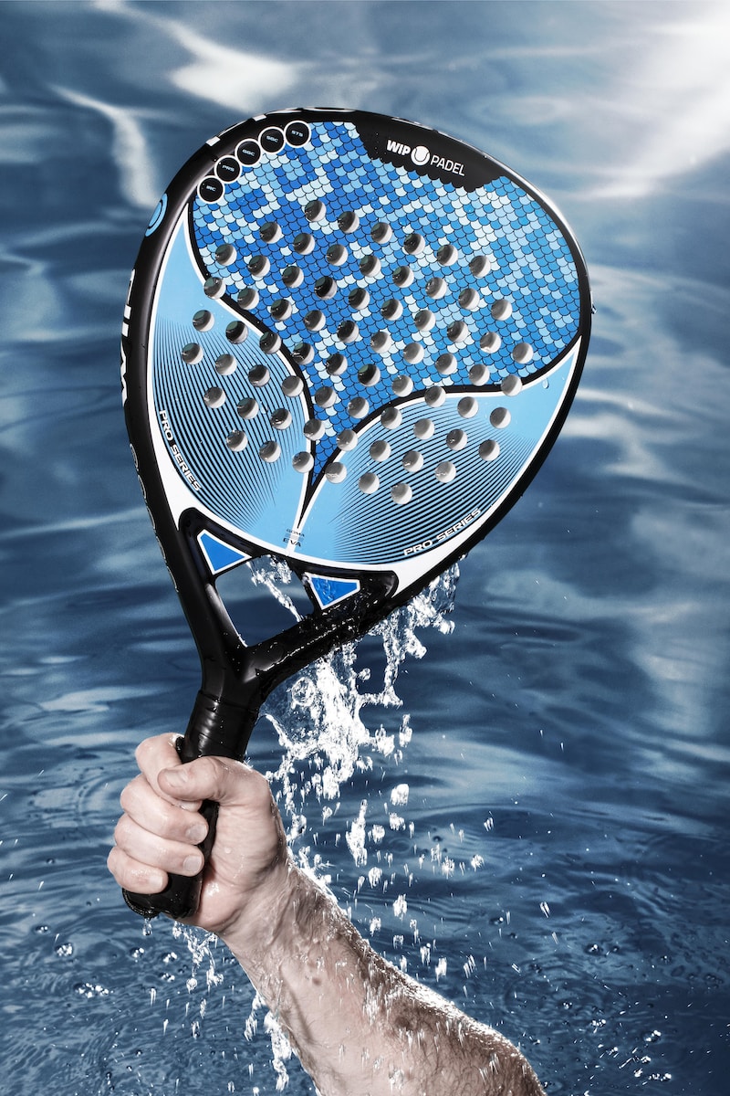 a person holding a tennis racket in the water